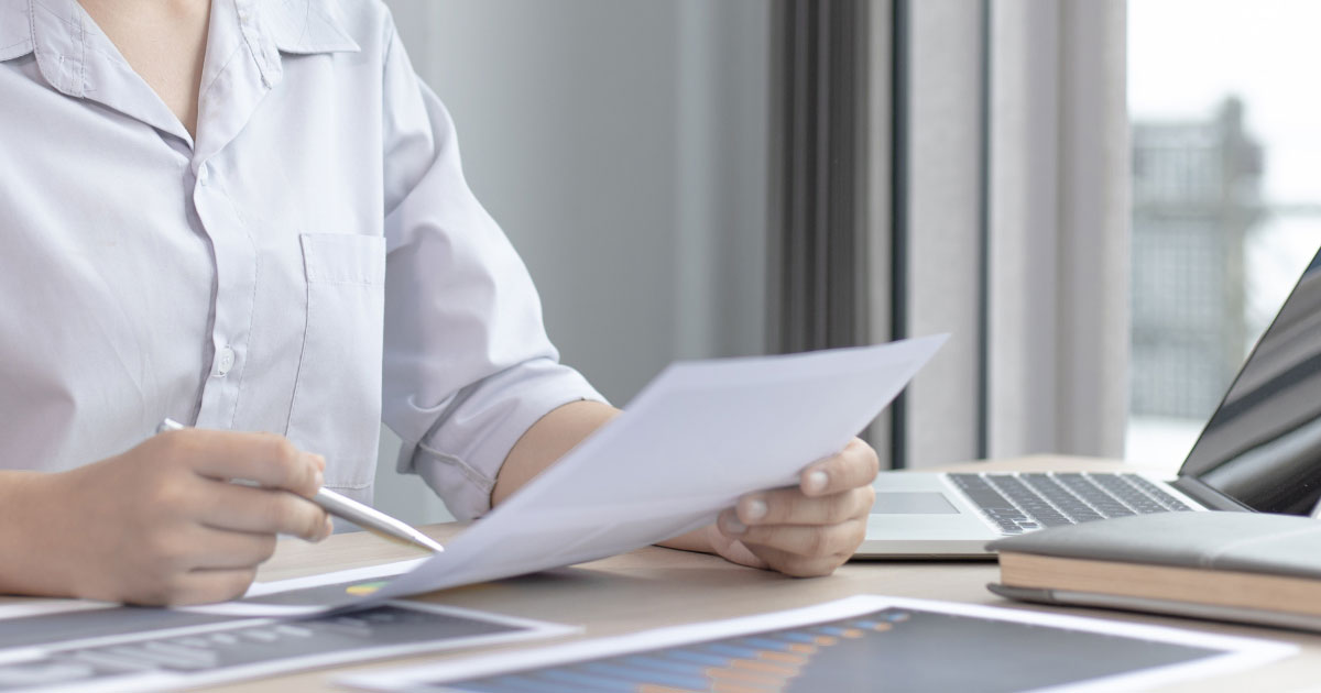 woman reading a paper report